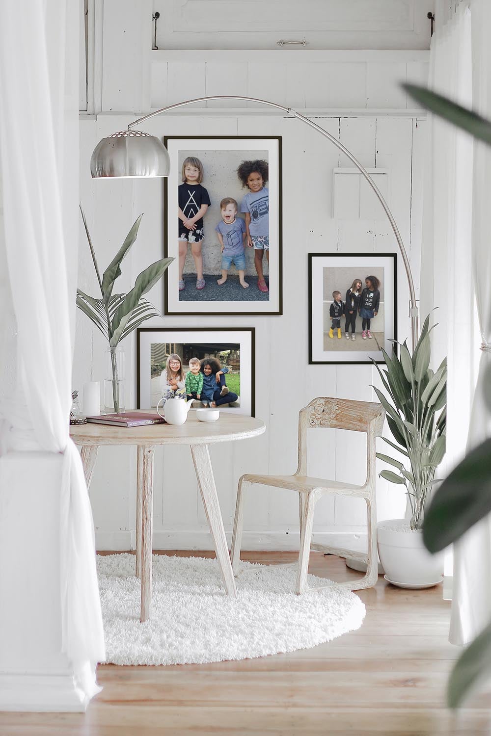 Asymmetrical gallery wall hung behind dining table