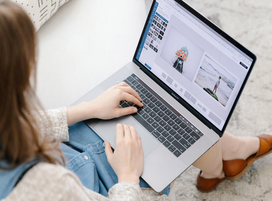 Woman creating photo book on laptop