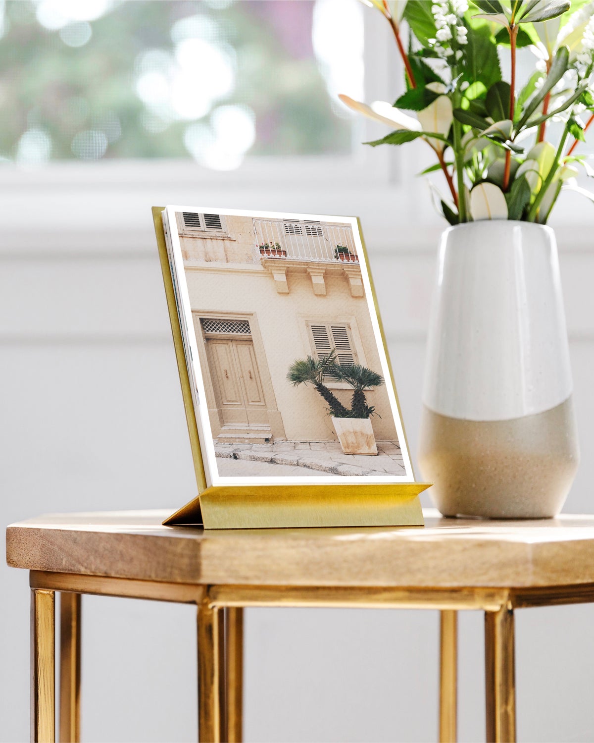 Brass easel calendar featuring monochromatic travel photo of mediterranean architecture