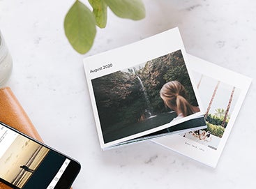 Artifact Uprising softcover photo book with woman in front of waterfall on cover