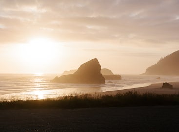 Photo of rock formations off the coast at golden hour