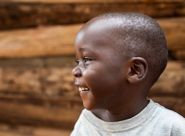 Little boy laughing with head turned to the side