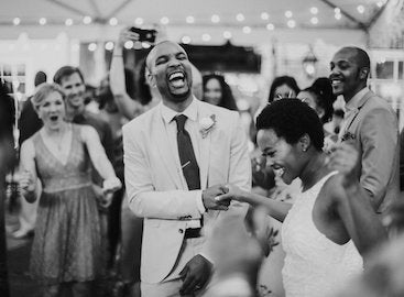 married couple on dance floor with friends