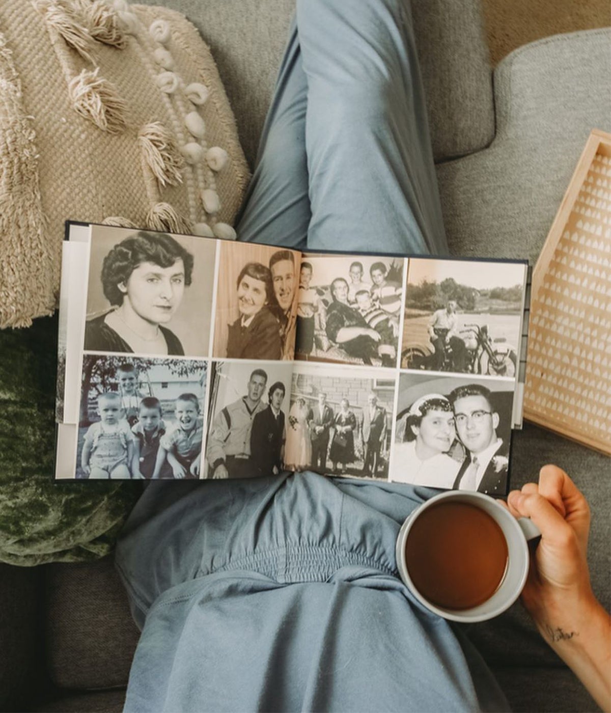 Family history book open on woman's lap