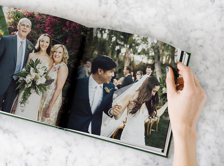 Layflat wedding album opened to side by side wedding photos